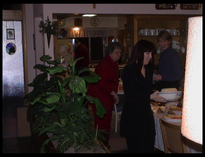 Christmas Eve at Elsa Going's house. Kate at table, Elsa in red.
