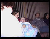 Sandra, Auntie Heather holding Logan, Grandpa Rick, and Grandma Zoe Ann.