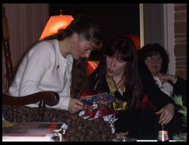 Kate looks interested in what someone else opened.