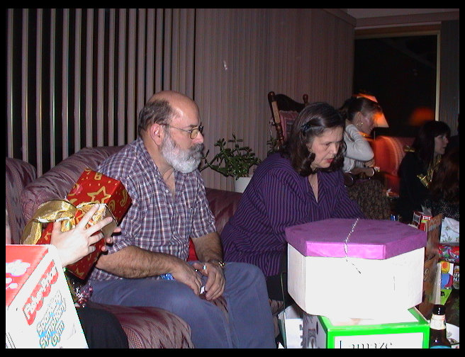 Grandpa Rick and Grandma Zoe opening presents.