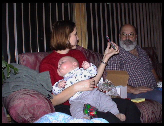 Heather showing a gift to Rick and Mom.