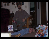 Uncle Dave looking at something across the room and Kaleb on the floor.
