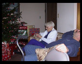 Nonnie and Uncle Ron opening gifts.