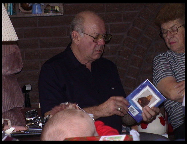 Grandpa opening a gift.