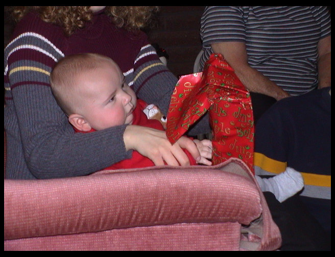 Logan is helping open a present.