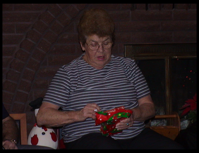 Grandma is opening a present.