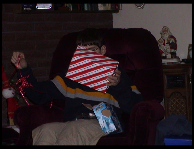 Tyler opening another present.