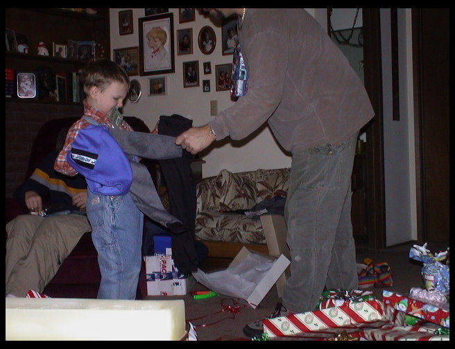Uncle David looking at Kaleb's gift.
