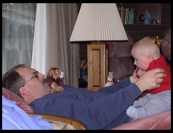 Uncle Ron holding Logan and Logan's new lion from Jennifer.