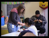 Sarah Hastings standing, David Lee in hat and Probjaht Basi in white.