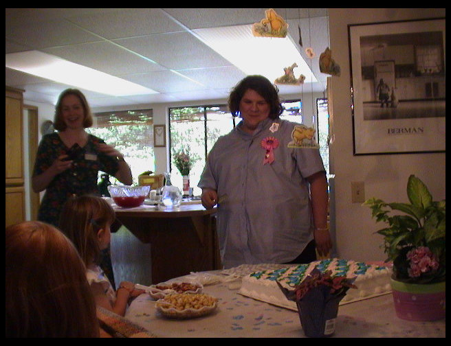 Kristi Ross and Sandra Gleason looking at teh cake.