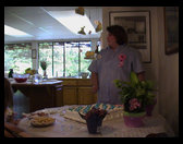 Sandra deciding how to cut the cake.