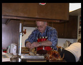 Grandpa Trogdon carving the turkey for Thanksgiving dinner.