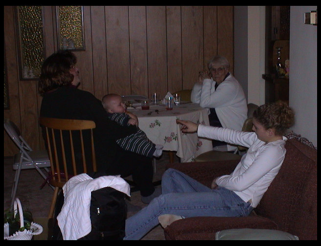 Jennifer Trogdon on couch, Sandra holding Logan and Nonnie in white.