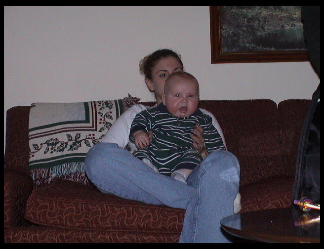 Jen holding Logan...Logan looks cranky.