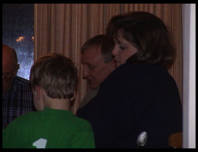 Some sit at the table to eat dessert.