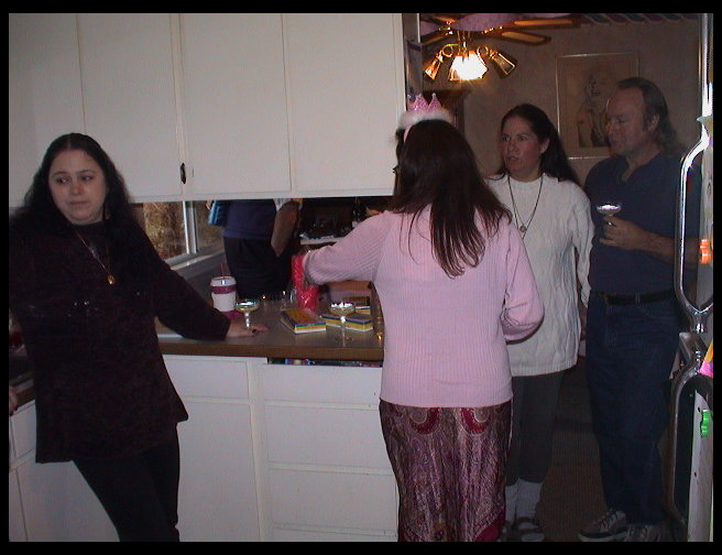 Alex Peterson standing in doorway, Juliet behind her, Donna Kennedy in Mariners shirt and Scott Jones back to the camera.
