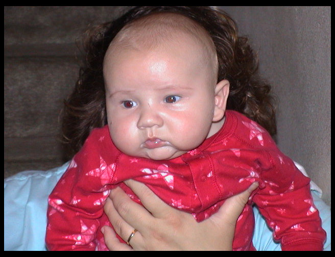 Logan being held by mommy.