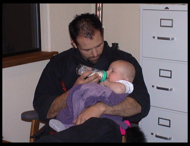 Logan enjoying being cuddled by Mr. Graves.