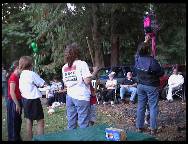 Mrs. Mustard (Monica) reinforces the piñata with some duct tape