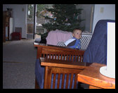 Logan kind of standing in front of our Christmas Tree.