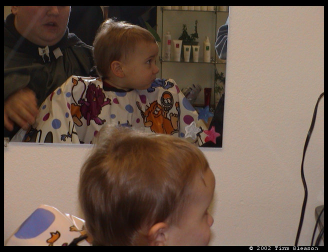 Logan with the haircut cape on.