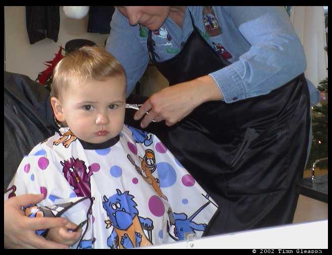 Vicki cutting Logan's hair.