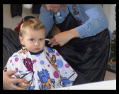 Vicki cutting Logan's hair.