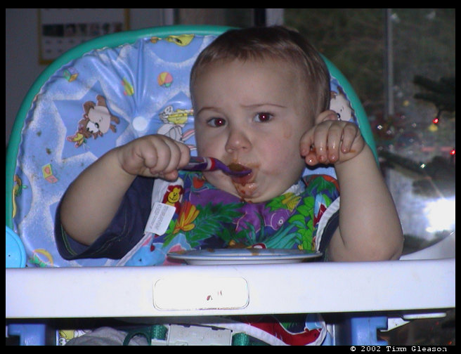 Logan using his spoon like a big boy.