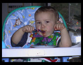 Logan using his spoon like a big boy.