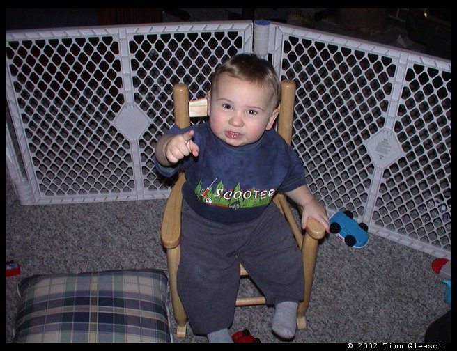 Pointing at the camera.