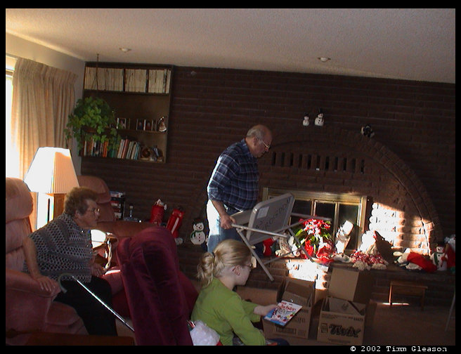 Mom, Dad and Lisa getting ready to open presents.