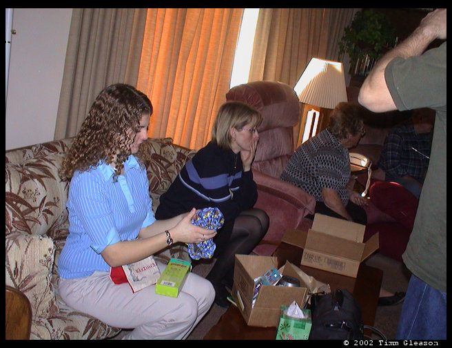 Jennifer, Marianne and Grandma/Mom looking at stocking stuff.