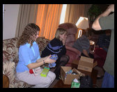 Jennifer, Marianne and Grandma/Mom looking at stocking stuff.