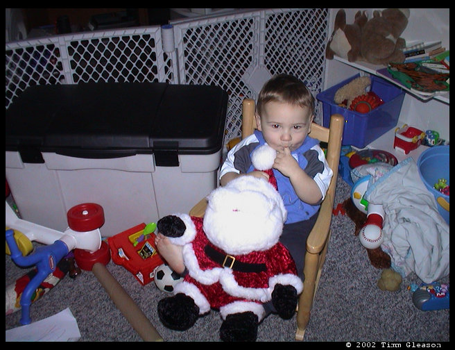 Logan and his new Santa and new rocking chair.