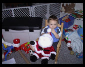 Logan and his new Santa and new rocking chair.