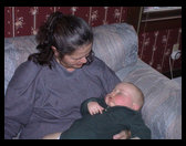 Grandma Zoe holding a tired boy on Grandpa Rick's birthday.