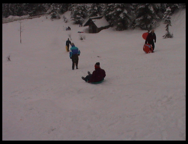 Jennifer sliding down the hill.