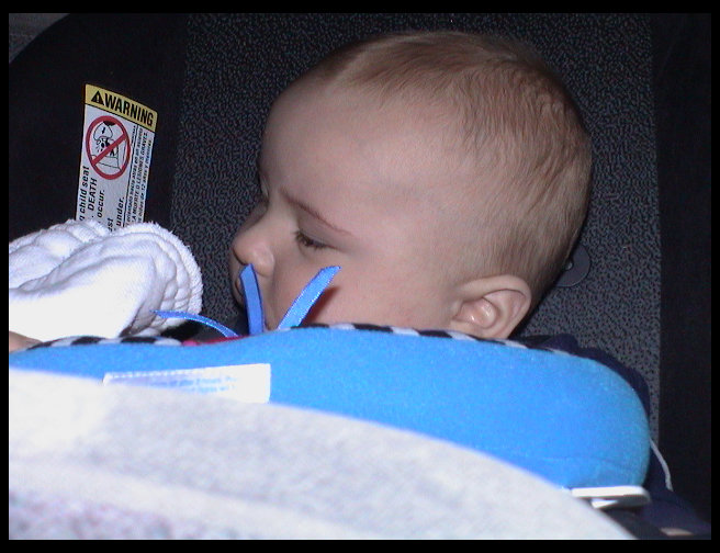 Logan sitting in his car seat.