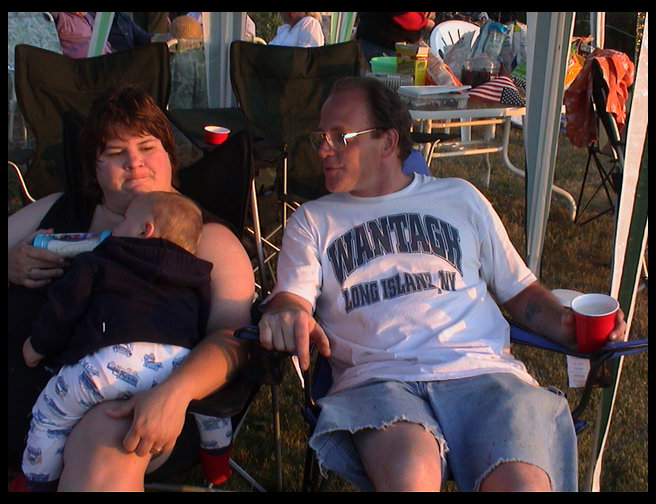 Sandra holding Logan and Eric visting.