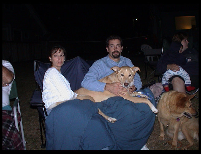 Maya being held by Mark and Connie.