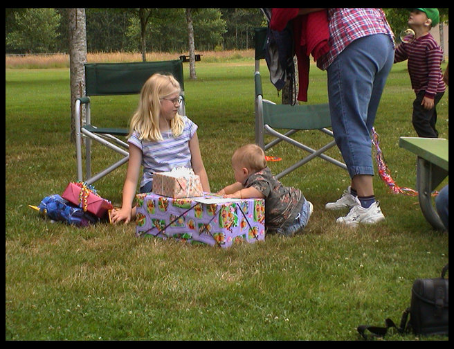 Lisa and Logan preparing to open presents.