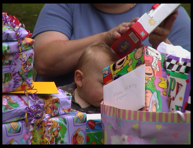 Logan is buried by presents.