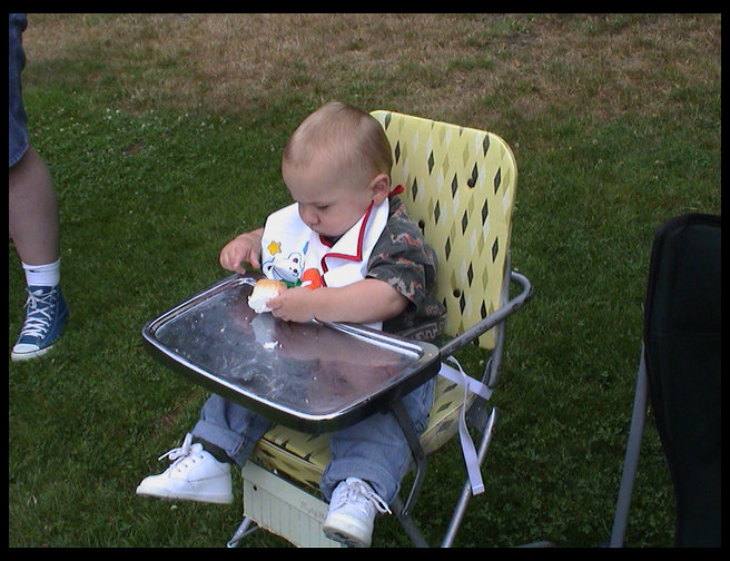 Logan looking at his first cake.