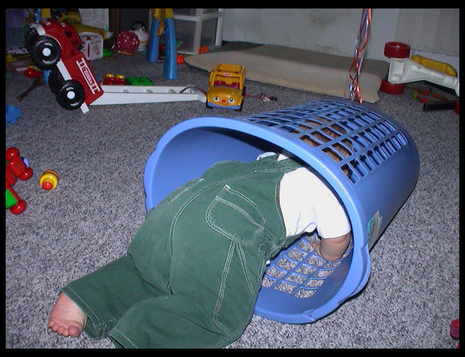 Logan crawling in his laundry basket.
