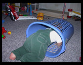 Logan crawling in his laundry basket.