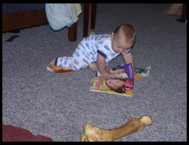 Logan ready for bed enjoying one of mom's baby magazines.