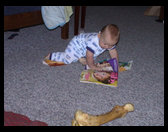 Logan ready for bed enjoying one of mom's baby magazines.