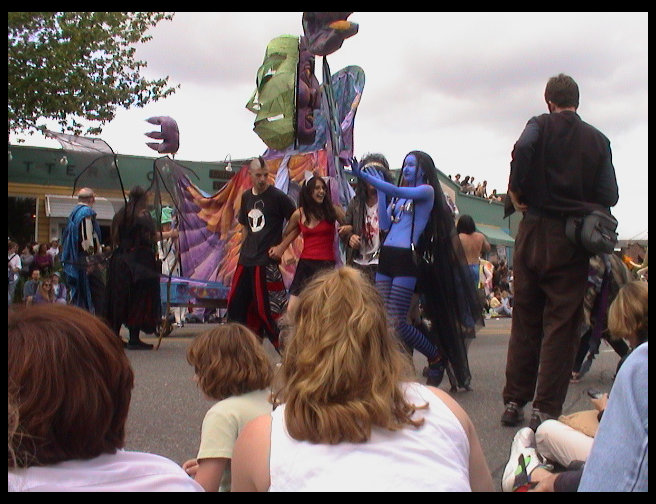 More partial naked people and colorful float.