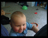Trying to crawl up in daddy's lap to get the camera.